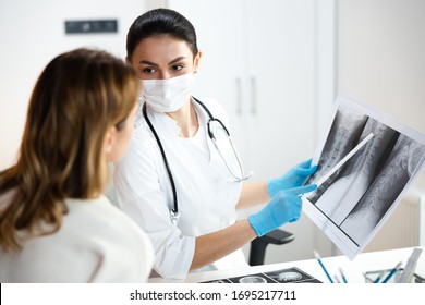 Caucasian Doctor Showing With Pointer Scoliosis Of Kid Spine Stock Photo. Pediatrics Concept