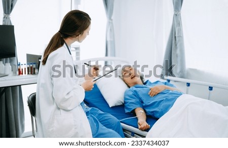 Similar – Doctor giving a prescription to senior patient