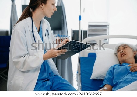  Caucasian doctor smiling take care of a young patient in hospital. Friendly nurse or therapeutic treat client Professional medical service concept.
