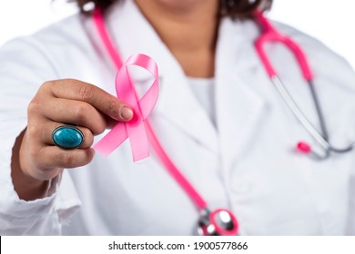 Caucasian doctor woman with pink stethoscope holding breast cancer pink ribbon on a white background. - Powered by Shutterstock