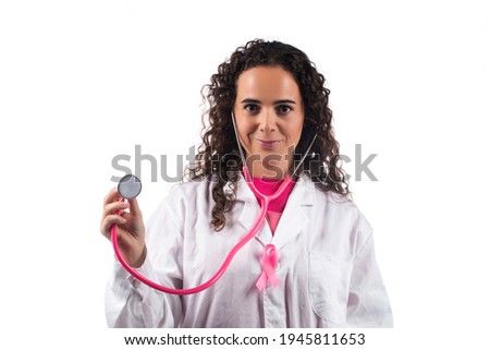 Caucasian doctor woman with pink stethoscope with breast cancer pink ribbon on a white background.
