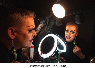 Caucasian Drag Queen At Mirror In Dressing Room