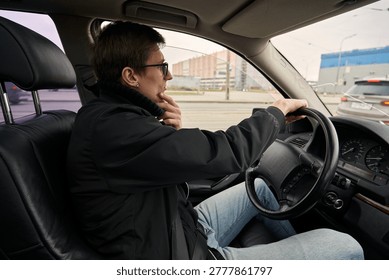 Caucasian driver checking route and thinking while driving