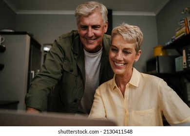 Caucasian Elderly Couple Looking At Laptop Screen