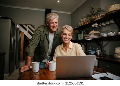 caucasian elderly couple smiling while talking to friends on video call - Powered by Shutterstock