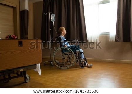 Similar – Senior woman in wheelchair alone in room