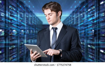 Caucasian IT engineer activating digital database server room with a digital tablet.