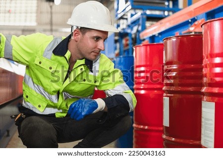 Caucasian engineer man with red color gasoline tank at factory 