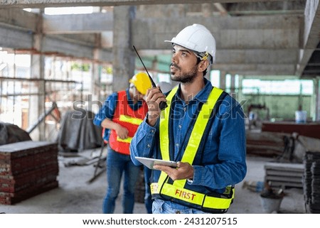 Caucasian engineer with radio walkie talkie in full safety gear is inspecting the crack and leak inside building structure for investigation over specification and quality control