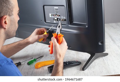 Caucasian Engineer Repairing Tv At Home.