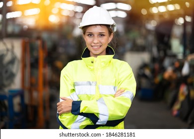 Caucasian engineer Woman worker at Metal lathe industrial manufacturing factory. portrait of cheerful young Asian woman wearing white hardhat helmet smiling happily looking at camera
