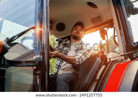 Caucasian ethnicity man driving farm or construction tractor.