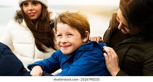 Caucasian family enjoying outdoor time. Family bonding outdoors. Family trip. Caucasian boy enjoy outdoor with his family. White boy having fun outdoor nature with parent. Mother and sister. Happy boy - Powered by Shutterstock