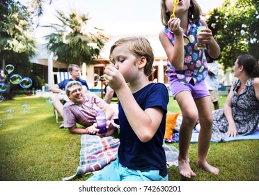 Caucasian Family Enjoying Summer Together At Backyard