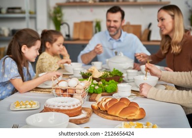 Caucasian family of five eating an easter dinner at home - Shutterstock ID 2126656424