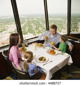 Caucasian Family Having Dinner Together At Tower Of Americas Restaurant In San Antonio, Texas.