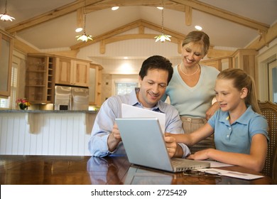 Caucasian Family Paying Bills On Laptop Computer.