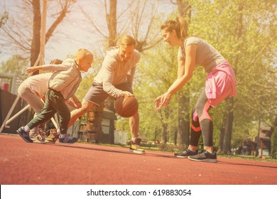 Caucasian Family Playing Basketball Together