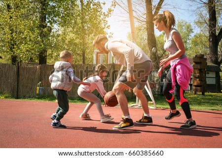 Caucasian family playing basketball together. Happy family spending free time together.