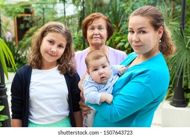 Caucasian Family Portrait With Adult Mother With Newborn Son And His Teen Age Sister, Grandmother Stands Behind