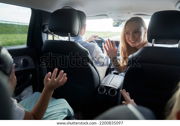 Caucasian family trip\
driving at the car