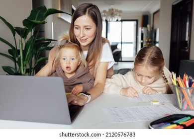 Caucasian family working and studying online at home and using laptop. Distance or remote learning for child. Pretty stylish schoolgirl studying homework math during coronavirus covid-19 quarantine