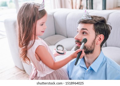 Caucasian Father And Daughter Playing At Home With Make Up Brush