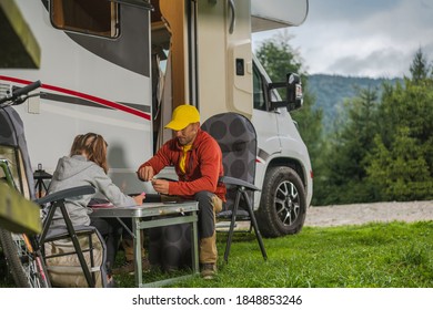 Caucasian Father with His Daughter Hanging Next to Modern Camper Van Class C Motorhome. Family RV Park Camping Theme. - Shutterstock ID 1848853246