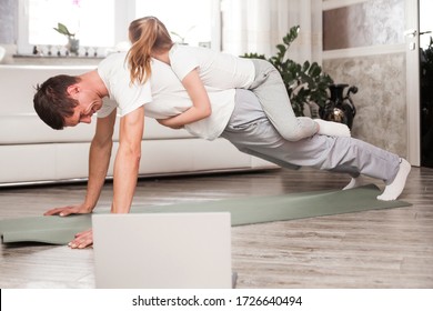 Caucasian father and small daughter in casual clothes do pushup pressup exercise on carpet on warm floor in living room, sporty lifestyle, getting physically stronger, have fun, pastime with kid - Shutterstock ID 1726640494