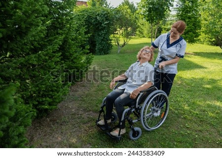 Similar – Granddaughter hugging grandmother in wheelchair