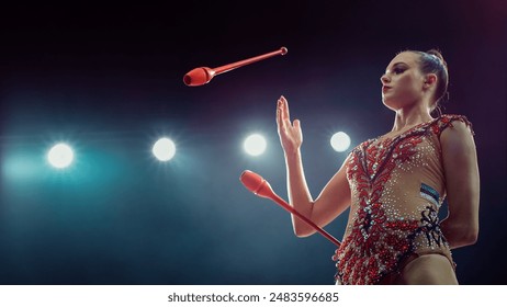 Caucasian Female Gymnast in Glittering Costume, Expertly Juggling Clubs Under Bright Stadium Lights, Her Precision, Strength, and Artistry in Captivating Rhythmic Gymnastics Performance. - Powered by Shutterstock
