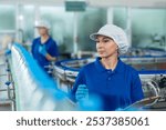 Caucasian female industry worker team working in factory warehouse. Attractive women industrial processing bottles of mineral water orders and food product at manufactory warehouse with happiness.