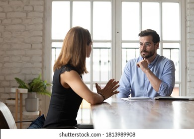 Caucasian Female Job Candidate Talk With Middle-aged Businessman Make Good First Impression At Interview In Office, Diverse Focused Business Partners Speak Negotiate At Meeting Or Briefing