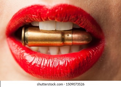 Female Lips Biting Bullet : Close Up Of Womans Mouth Biting Bullet Held ...