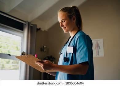 Caucasian female nurse writing exercises for patient standing in clinic  - Shutterstock ID 1836804604