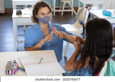 Caucasian Female Teacher Wearing Face Mask At School, Teaching Children At School Classroom. Education Back To School Health Safety During Covid19 Coronavirus Pandemic.
