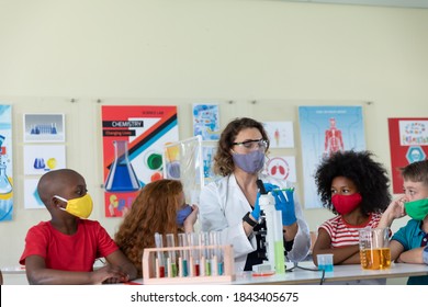 Caucasian Female Teacher Wearing Face Mask At School, Teaching Children At School Classroom. Education Back To School Health Safety During Covid19 Coronavirus Pandemic.