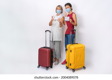 Caucasian Female Traveler With Suitcase Holding Coronavirus Covid-19 Vaccination Record Card With Passport To Use When Travel Aboard Isolated With Clipping Path