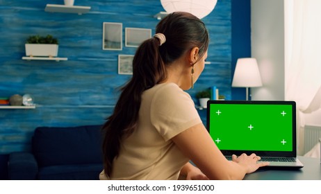 Caucasian Female Working On Laptop Computer With Mock Up Green Screen Chroma Key Display For Personal Business. Woman Typing On Isolated Pc Sitting At Desk Table In Office Home