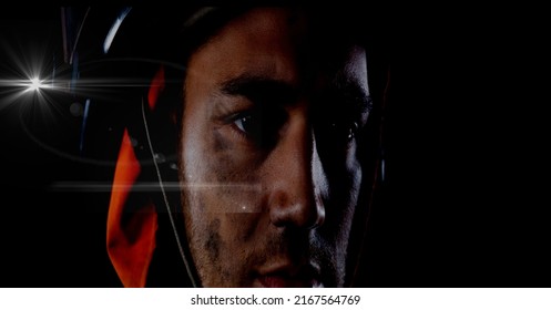 Caucasian Firefighter Wearing A Helmet Against Spot Of Light And Copy Space On Black Background. Safety Concept