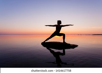 caucasian fitness woman practicing yoga on the beach at sunset  - Powered by Shutterstock