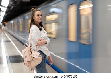 Caucasian Girl With Backpack Waiting For Train