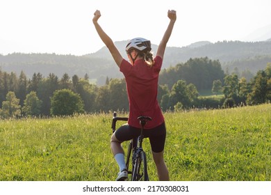 Caucasian Girl Cyclist With Professional Racing Sports Gear Riding On An Open Road Cycling Route