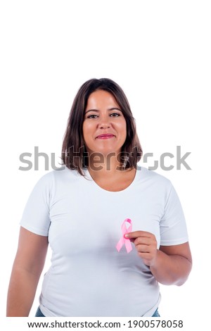 Caucasian girl holding breast cancer ribbon over a white background smiling.