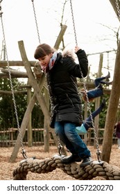 Caucasian Girl Playing On Merry Go Around