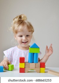 Caucasian Girl Playing with Wooden Colorful Cubes at Home Early Education Preparing for School Development - Shutterstock ID 688665253