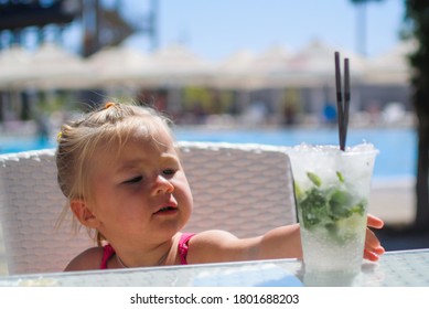 Caucasian Girl Portrait Drinks Mochito Next To Pool Close Up