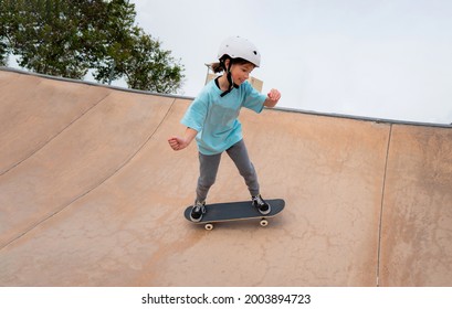 Caucasian Girl Skateboarding In A Skate Park