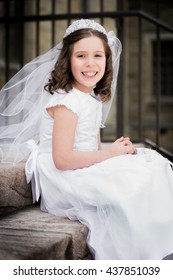 Caucasian Girl Wearing First Holy Communion Dress. Outdoors.