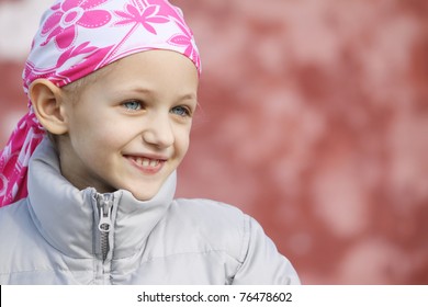 a caucasian girl wearing a head scarf as a result of hair loss due to chemotherapy - Powered by Shutterstock